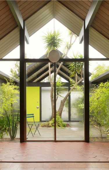 home interior with exposed beams and open-air courtyard