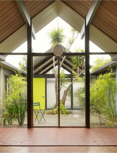 home interior with exposed beams and open-air courtyard