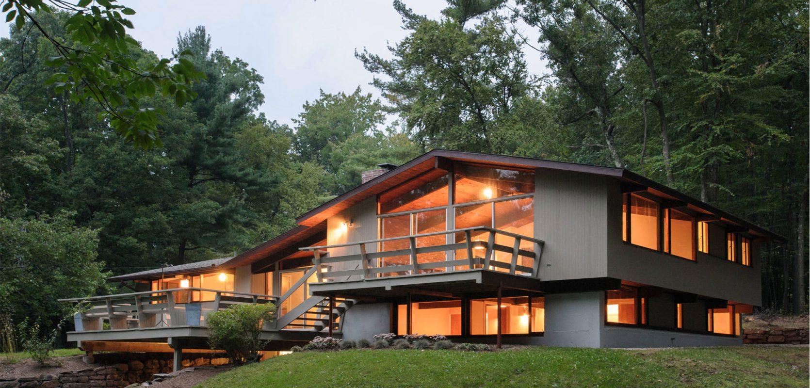 mid-century modern exterior glowing at dusk