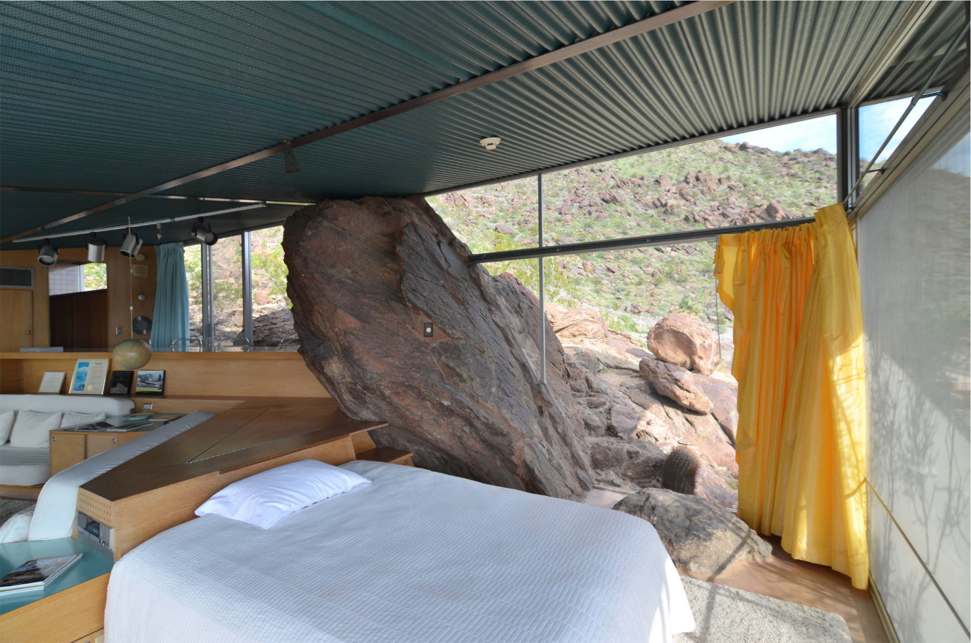 home interior built around boulder coming inside