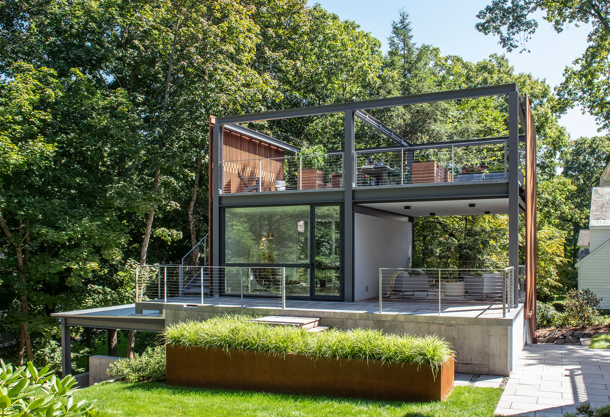 3-story studio garage structure with rooftop garden open-air veranda home office corten steel planter