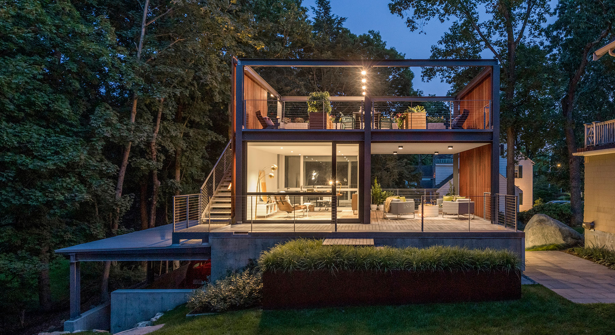 3-story backyard home office studio rooftop open-air veranda glowing at dusk