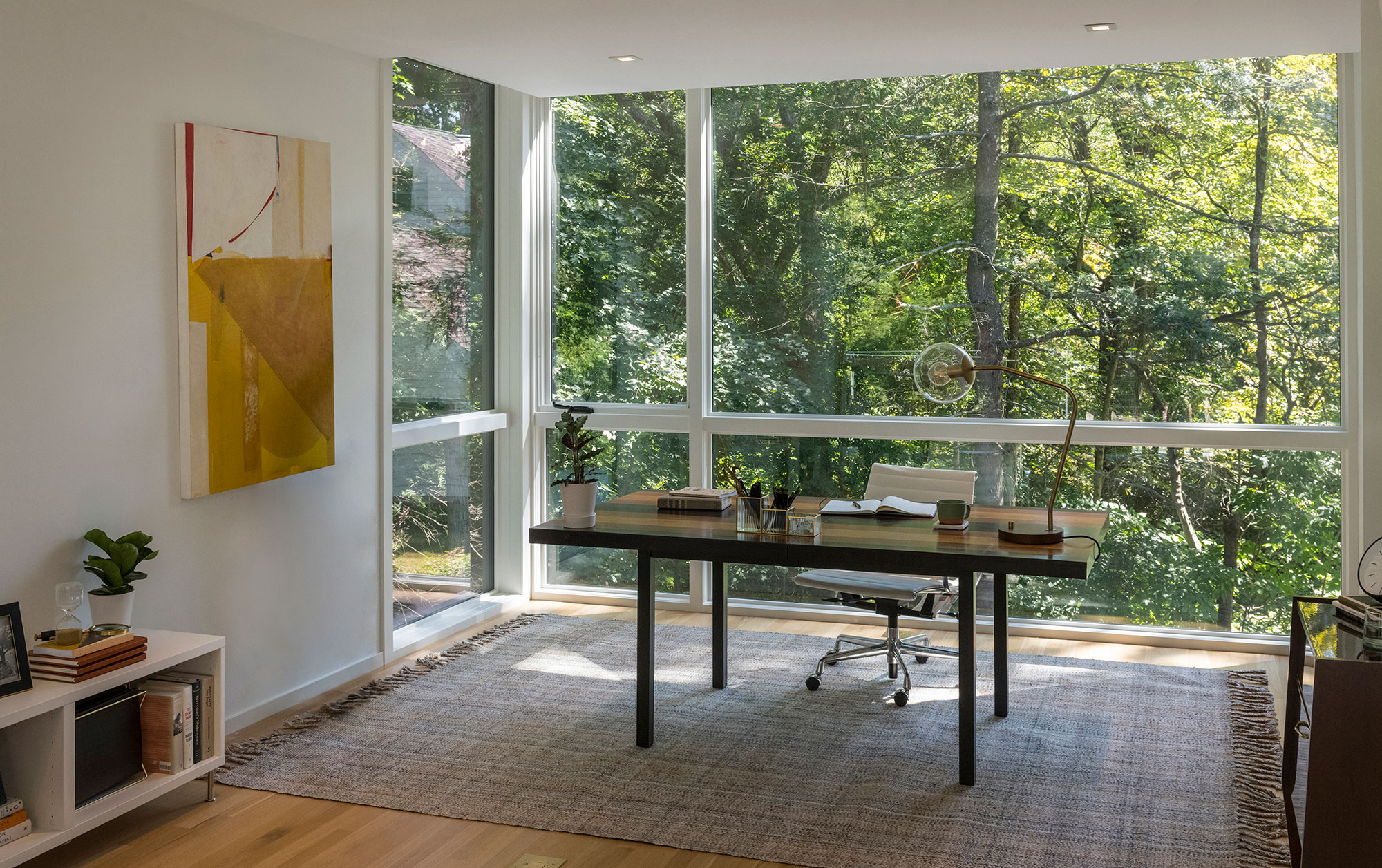 home office interior with forest view through large windows