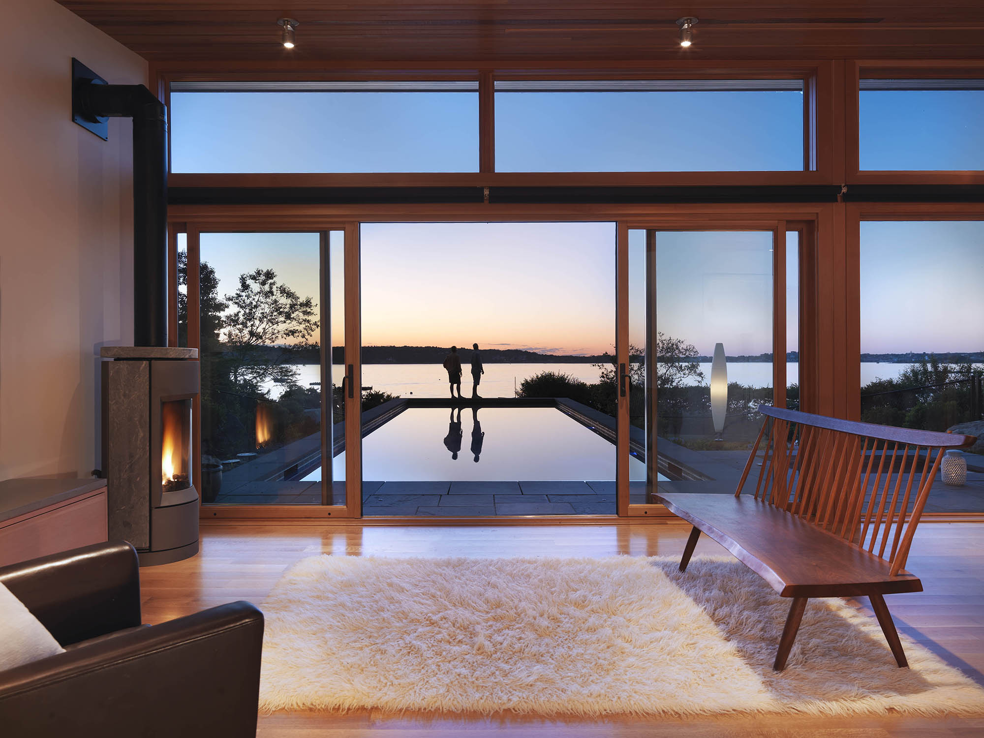 oceanside poolhouse cabana with wood burning stove at dusk