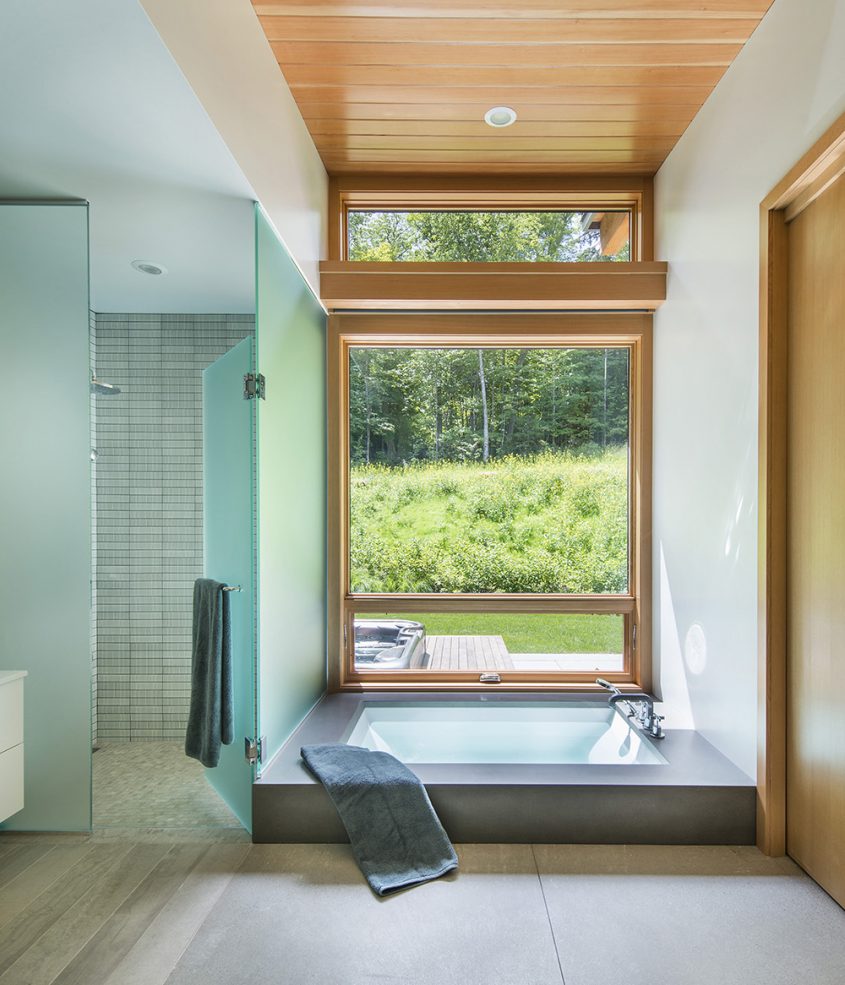 master bath with sunken soaking bath and window view