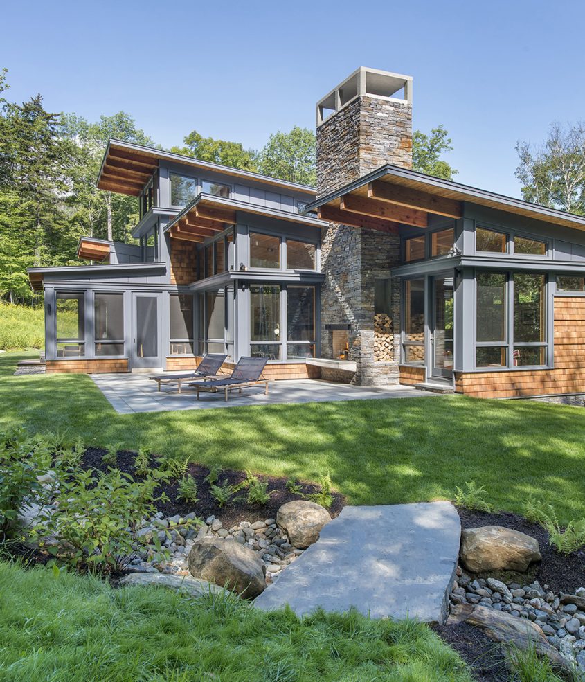 shed roof overhang with outdoor fireplace and patio