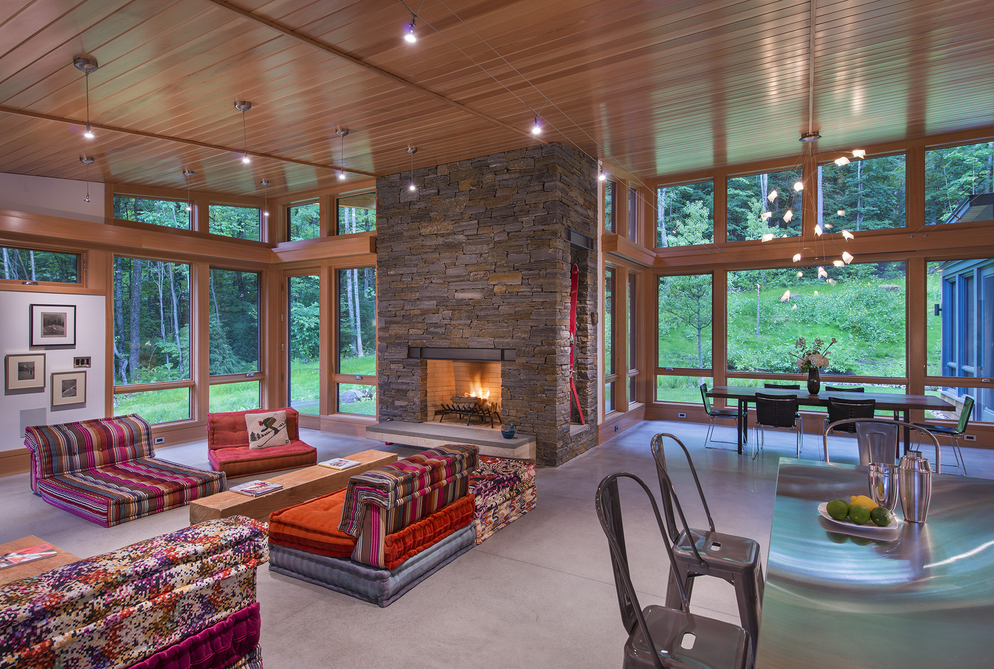 living room with large stone fireplace and wood ceiling