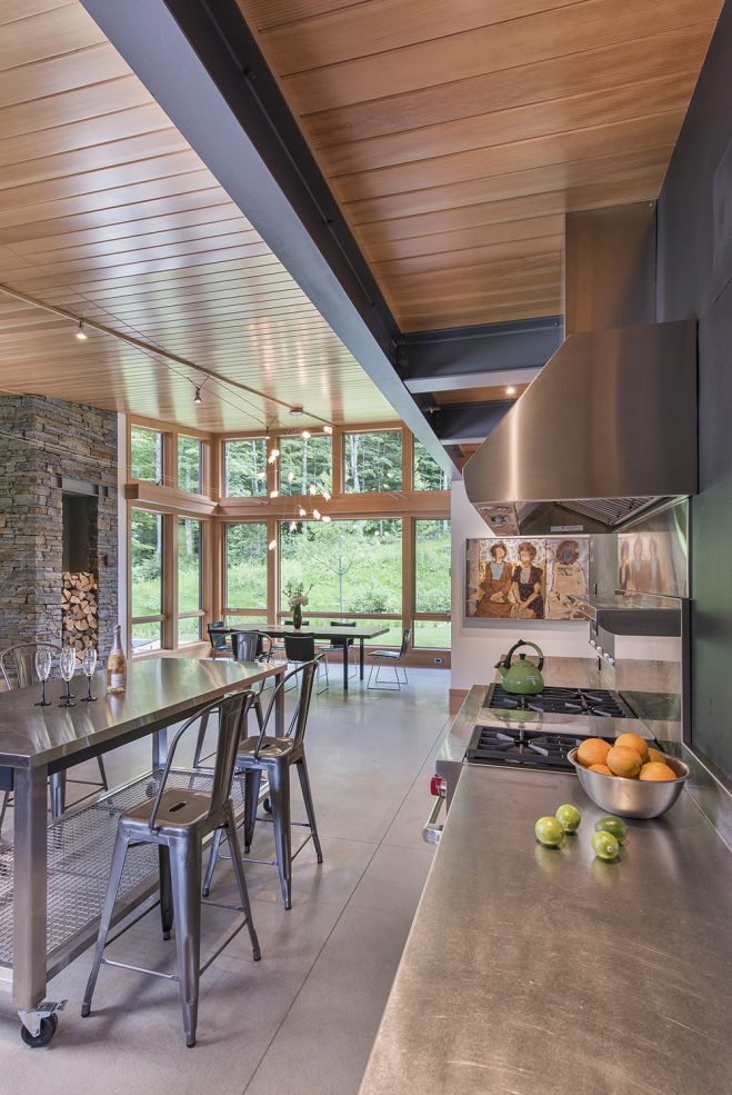 open layout of living kitchen and dining room with exposed steel