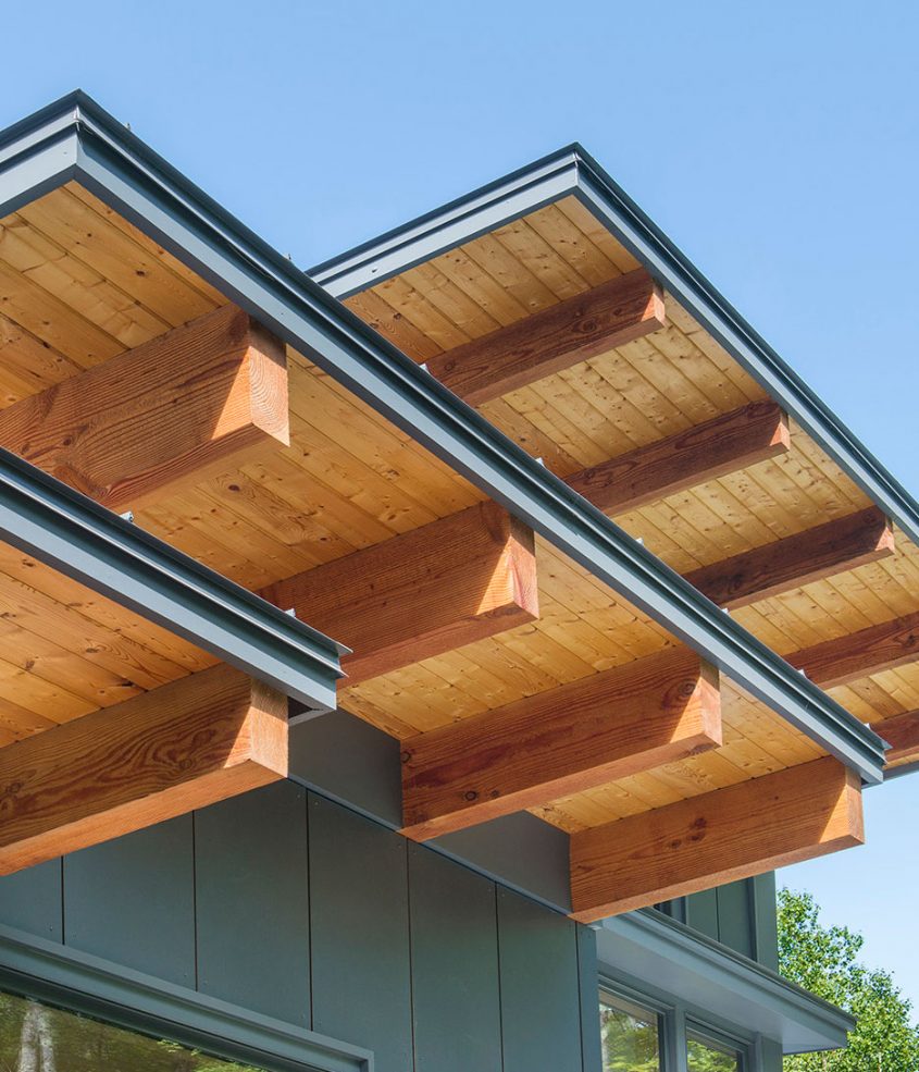 extended shed roof with wood soffits and exposed timber beams