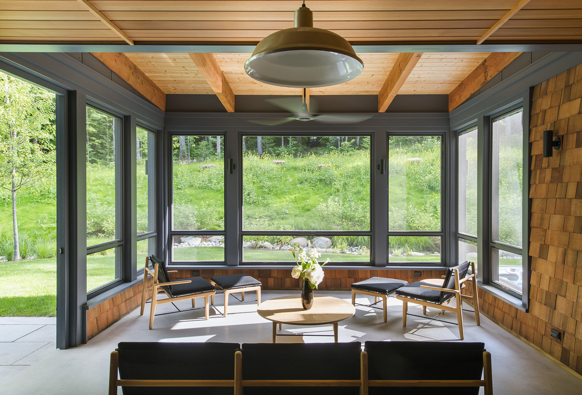 screen porch with exposed timber beams and wood ceiling