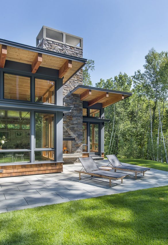 shed roof overhang with south facing patio and outdoor fireplace