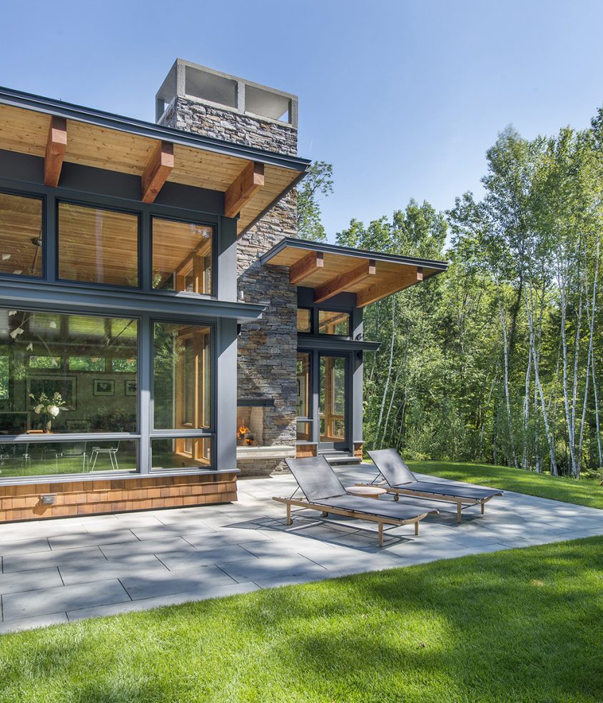 shed roof overhang with south facing patio and outdoor fireplace