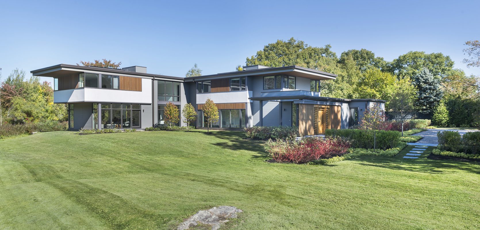 two-story modern home with cantilevered second floor and roof overhang