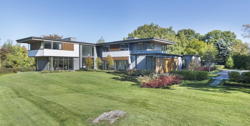 two-story modern home with cantilevered second floor and roof overhang