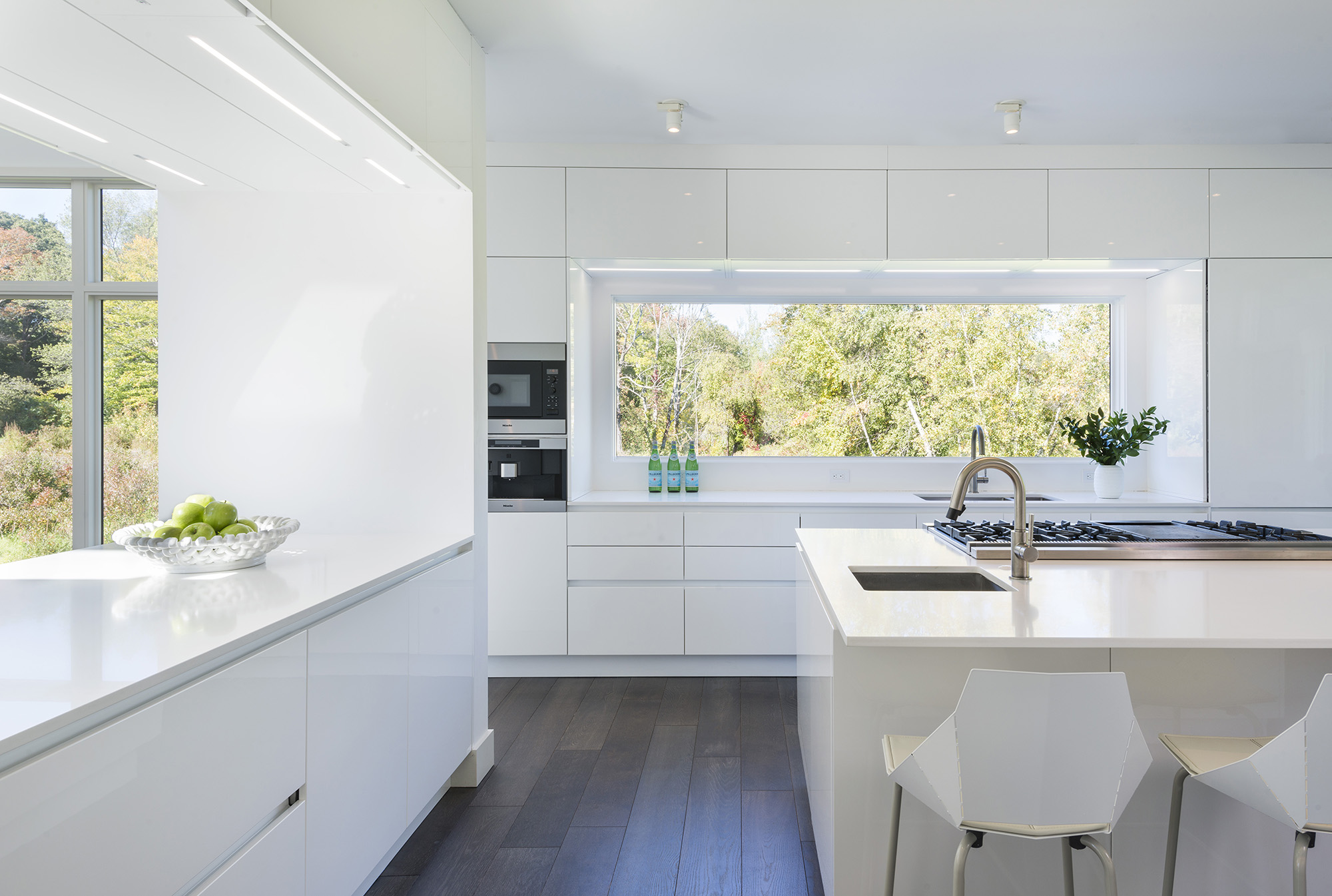 modern white kitchen with window backsplash