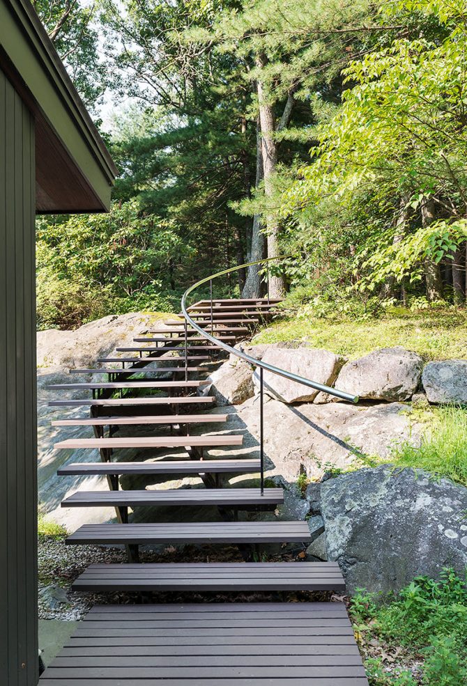 mid-century modern stair through natural rock ledge