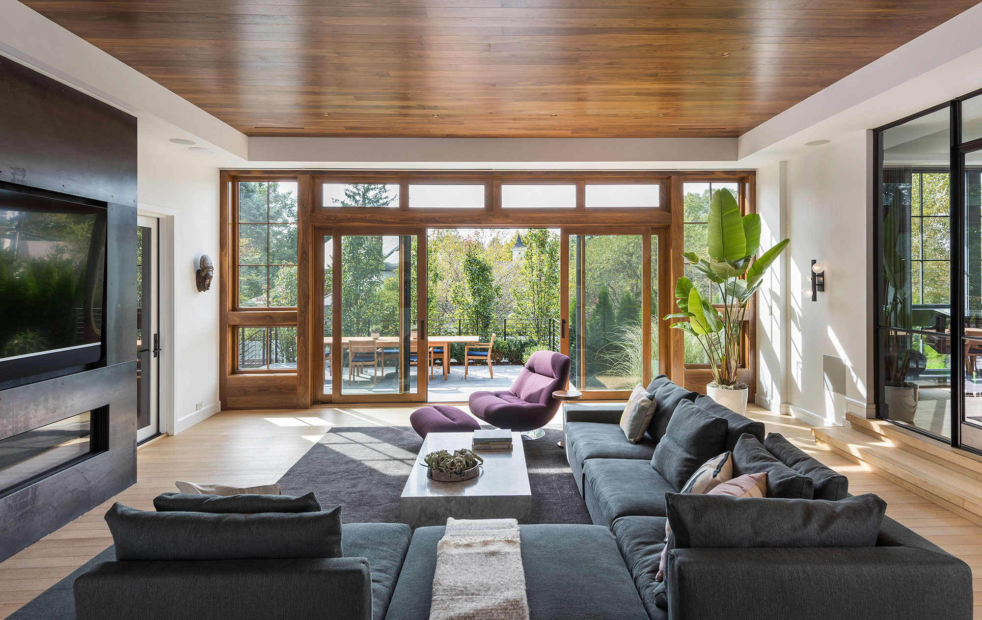 sectional couch in modern family room with sliding doors to outdoor terrace