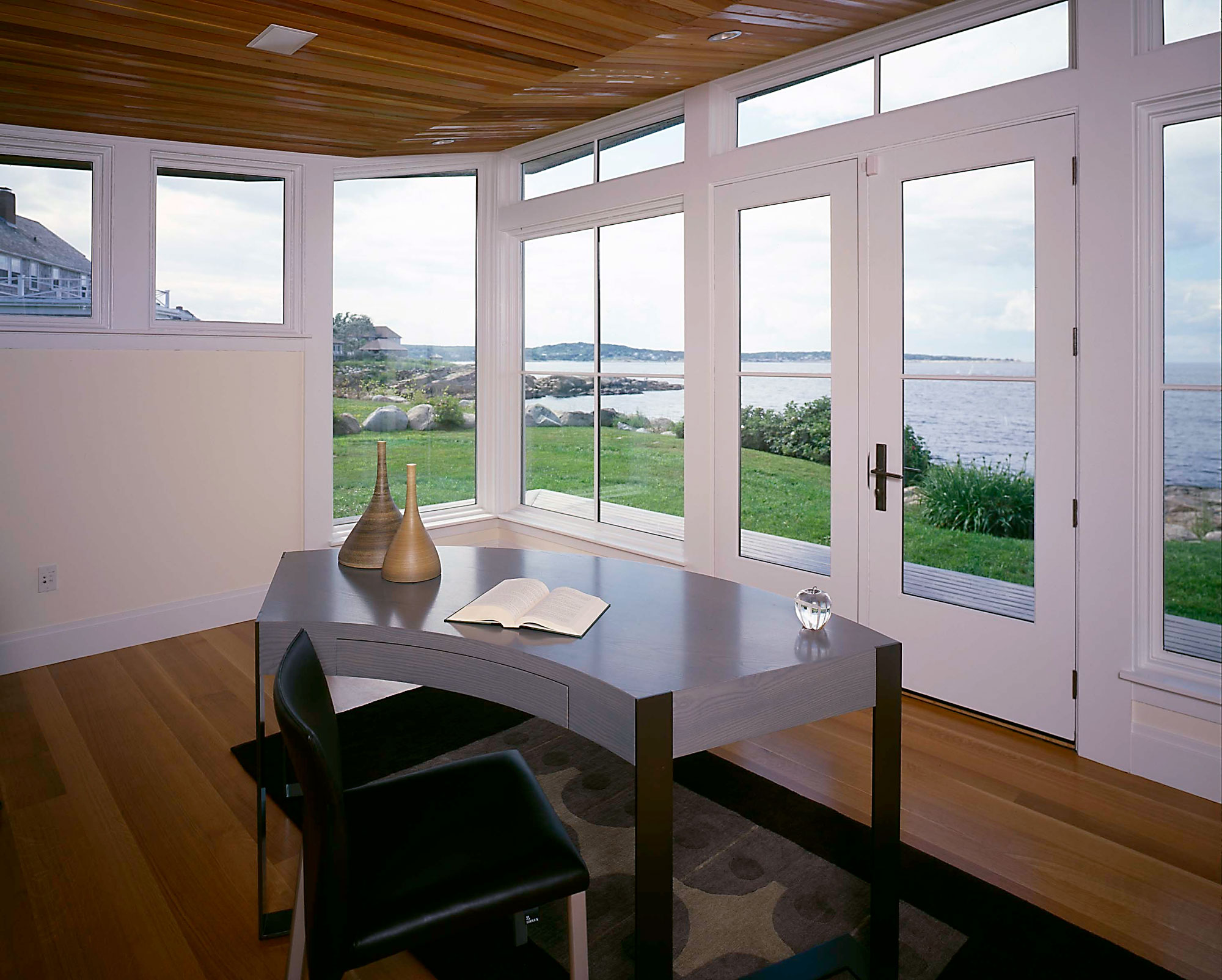 interior of home office with ocean views and wood ceiling