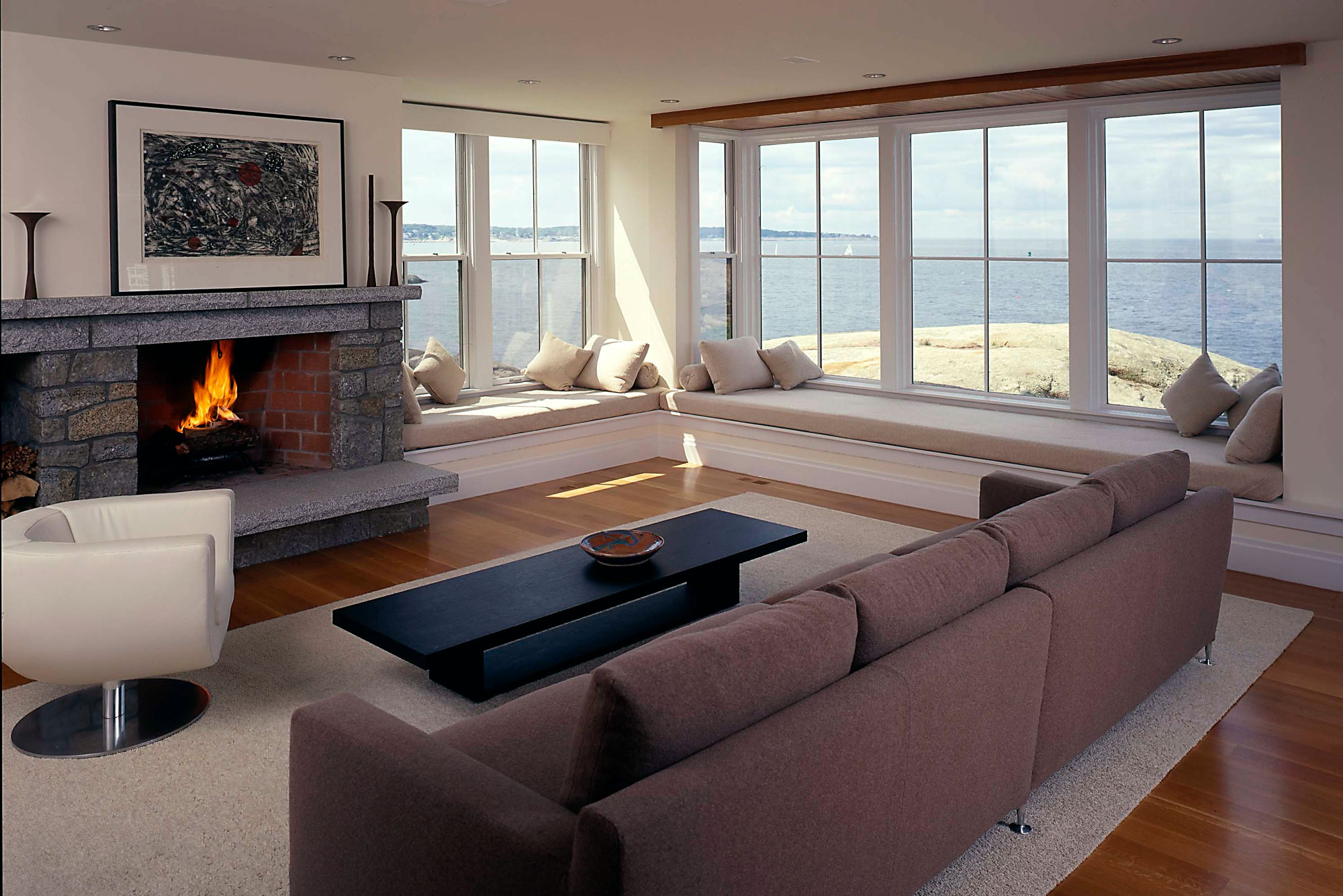 living room interior with fireplace and ocean views