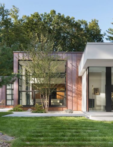 copper clad home with stucco and glass addition