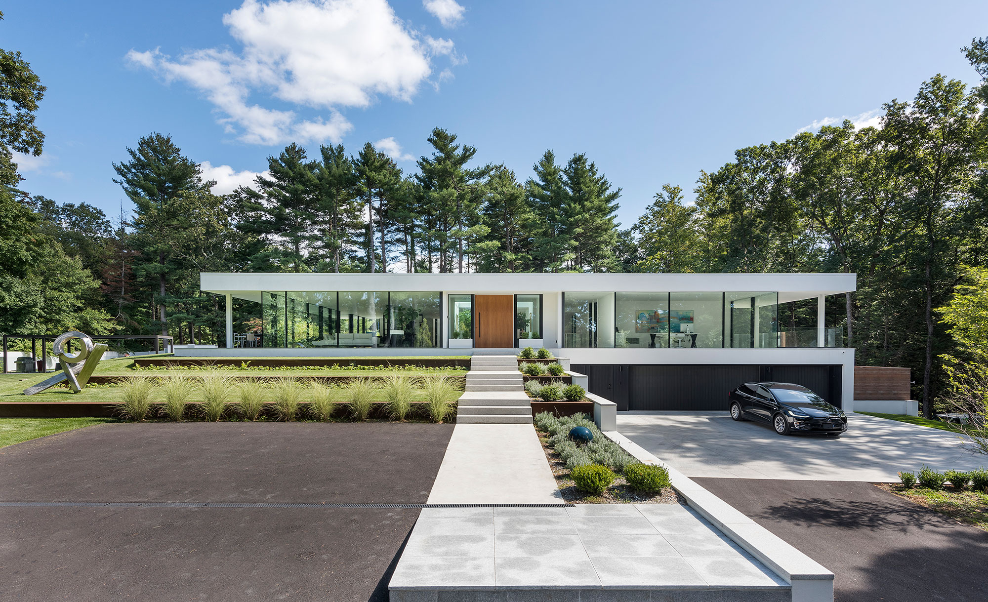 terrace entry to large wood pivot door and glass wall