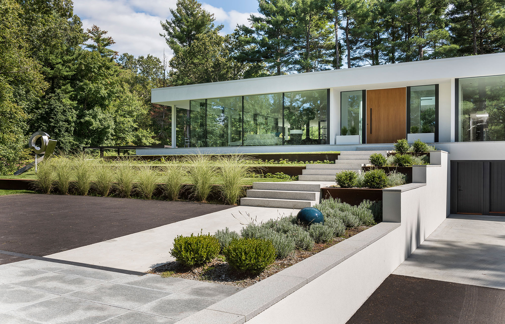 terrace entry to large wood pivot door and glass wall