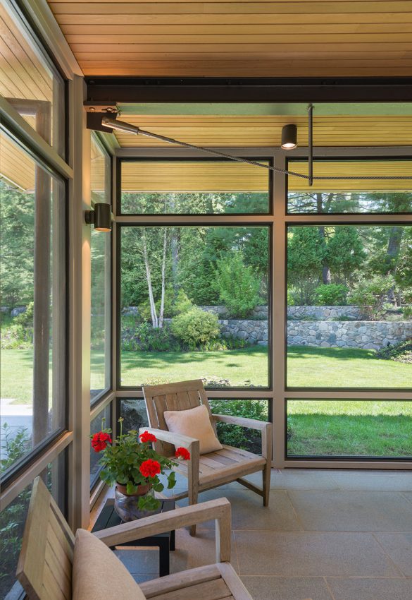 interior of screen porch with seating and extended wood soffits