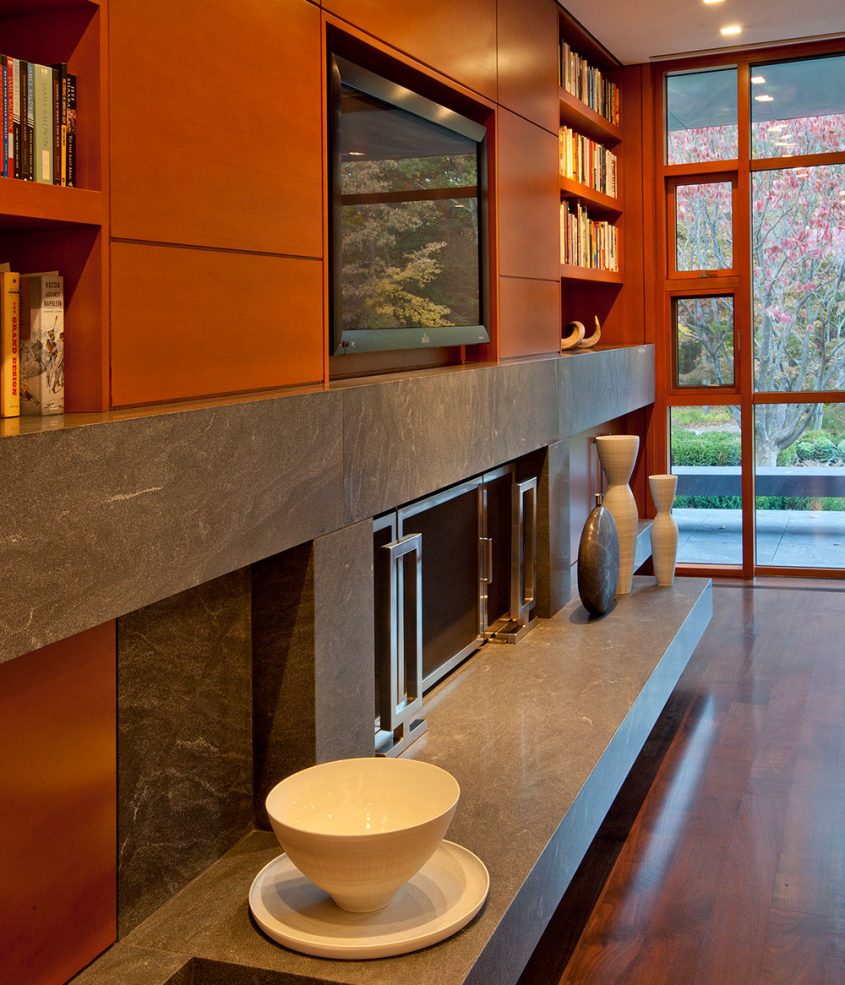 built-in cabinets with recessed tv and fireplace below
