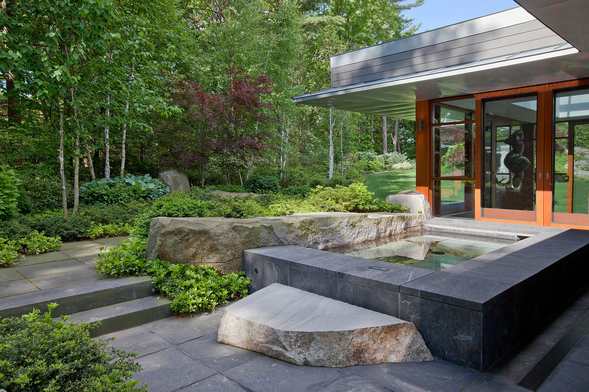 stone surround hot tub built into ledge