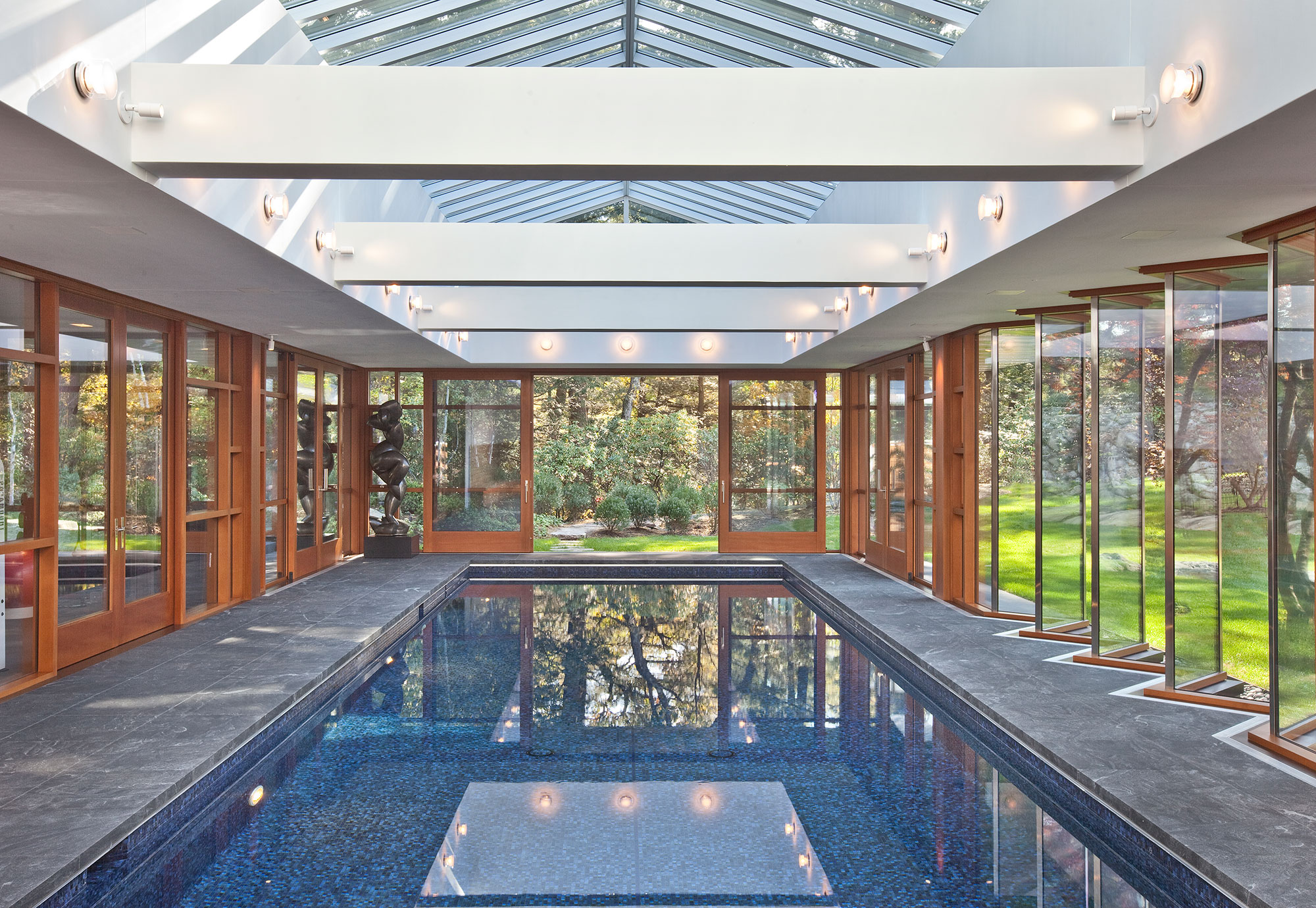 indoor swimming pool surrounded by glass