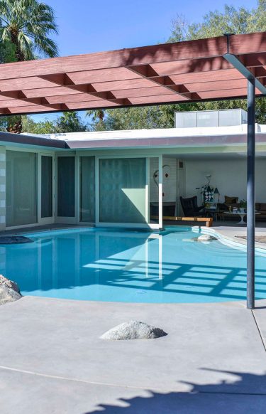 exterior view of mid-century modern home with pool in living room