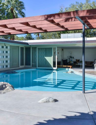 exterior view of mid-century modern home with pool in living room