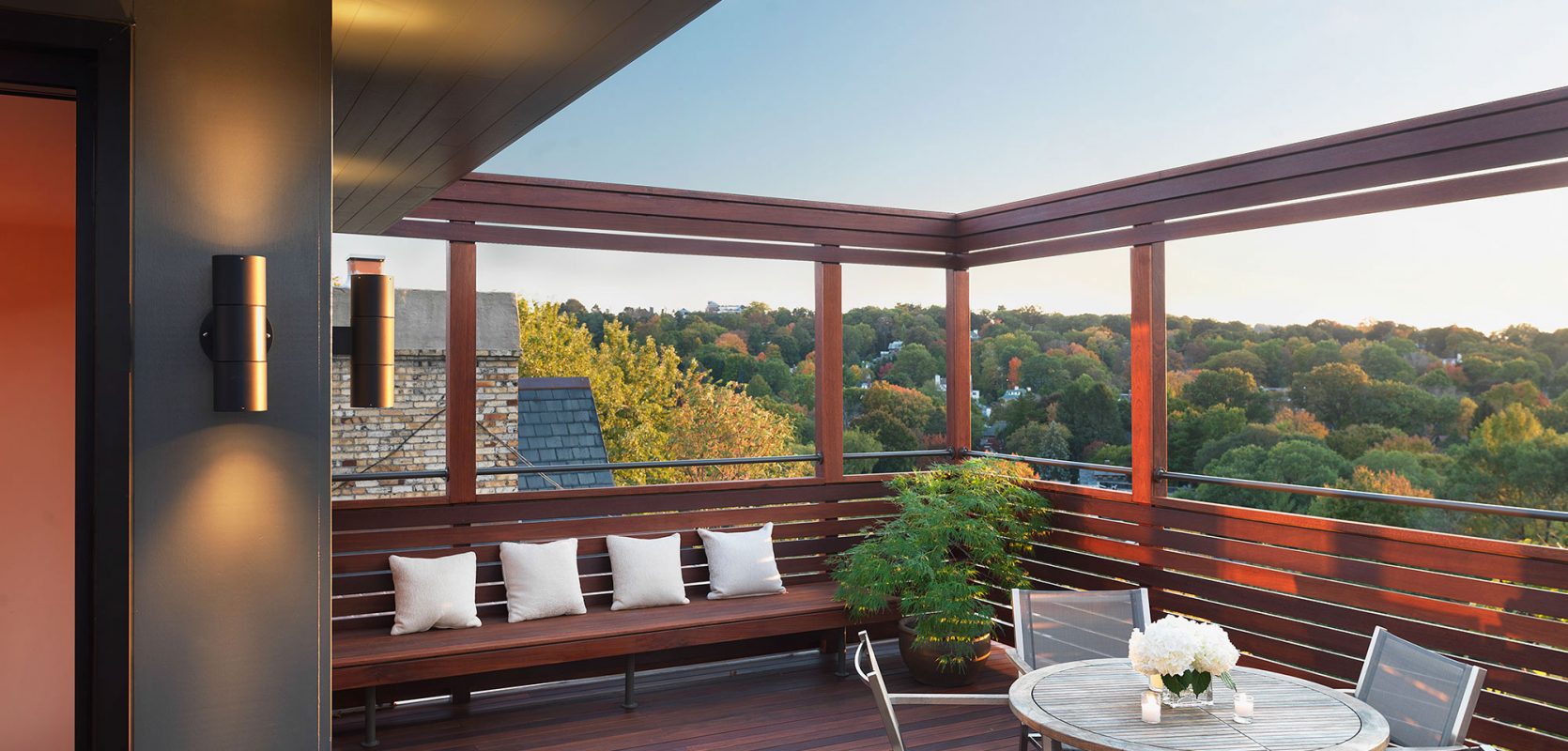 roof top view with built-in bench and tree tops in the distance