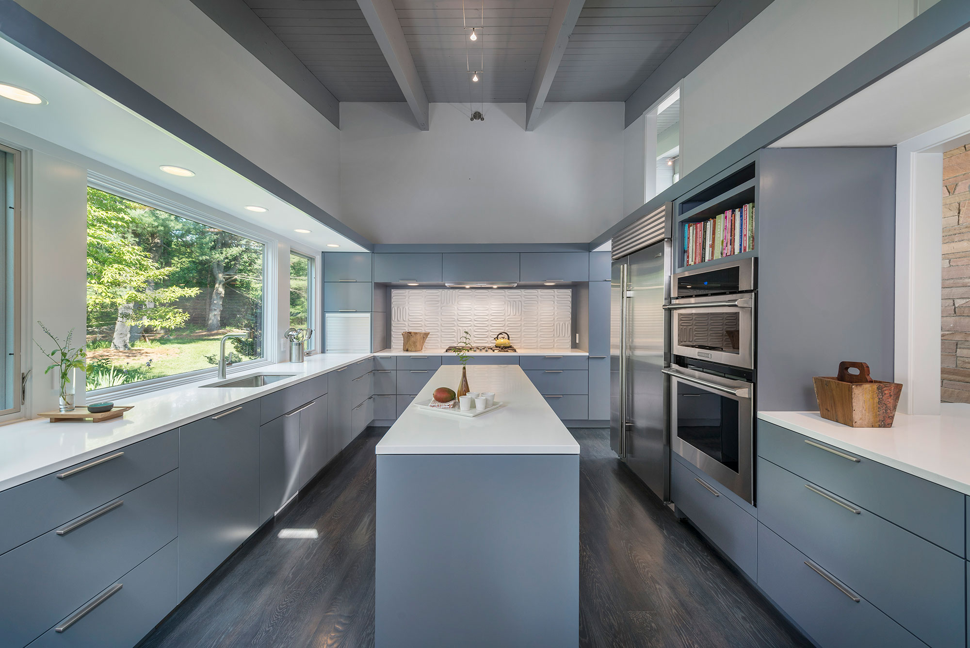 galley kitchen with island and window backsplash