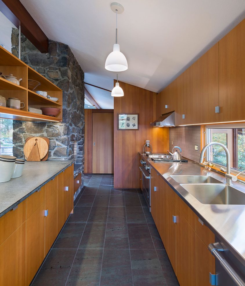 mid-century modern galley kitchen with wooden cabinets