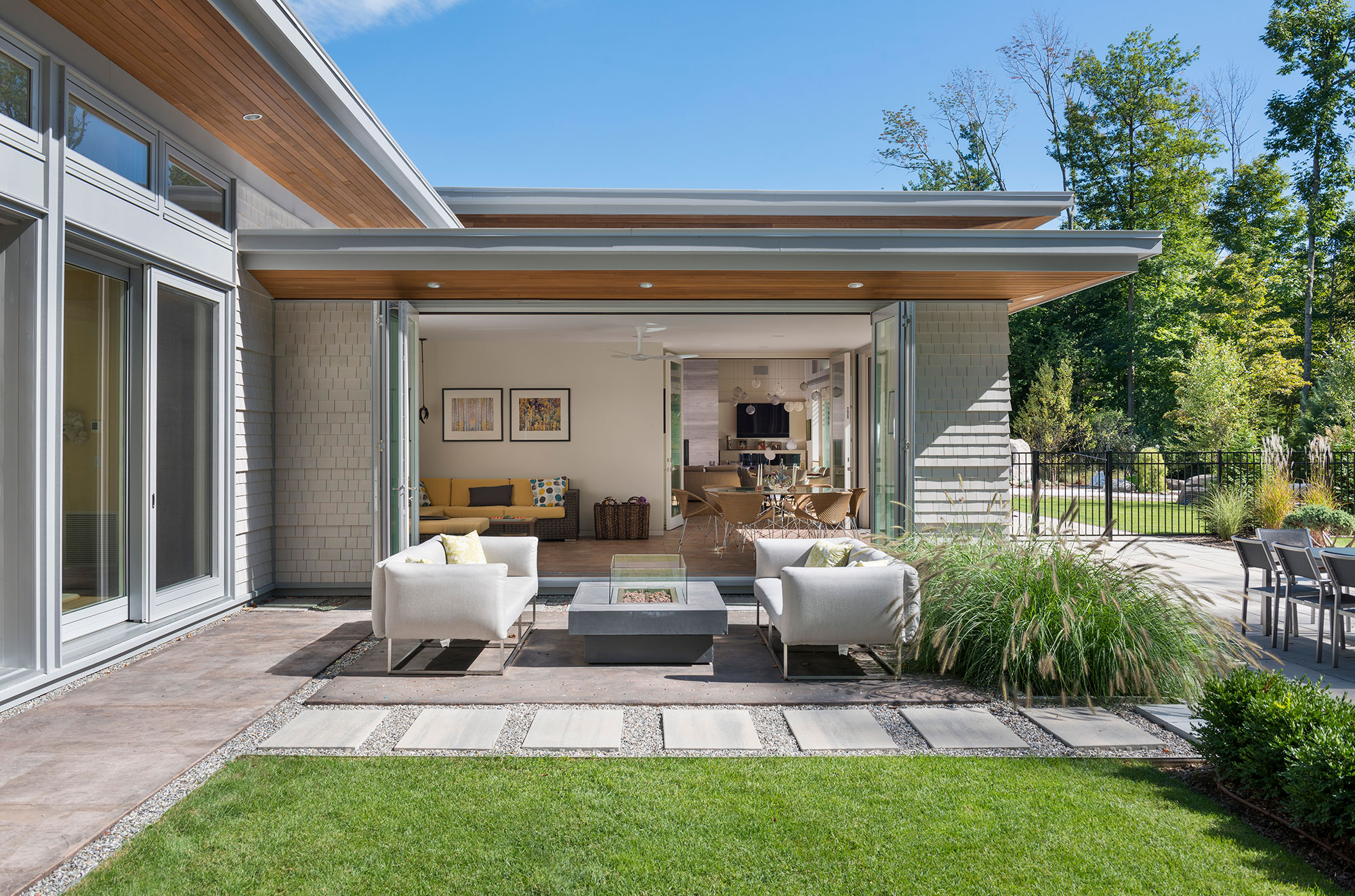 four season room with outdoor gas firepit on patio