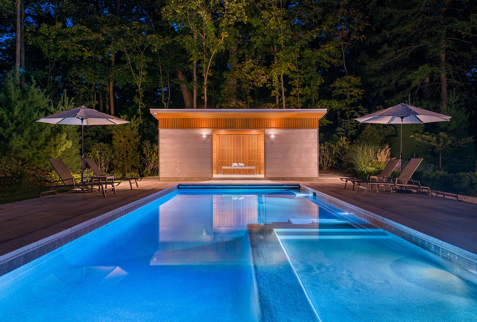swimming pool with cabana at dusk