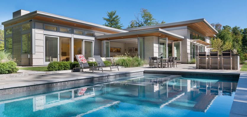rear exterior of home with swimming pool