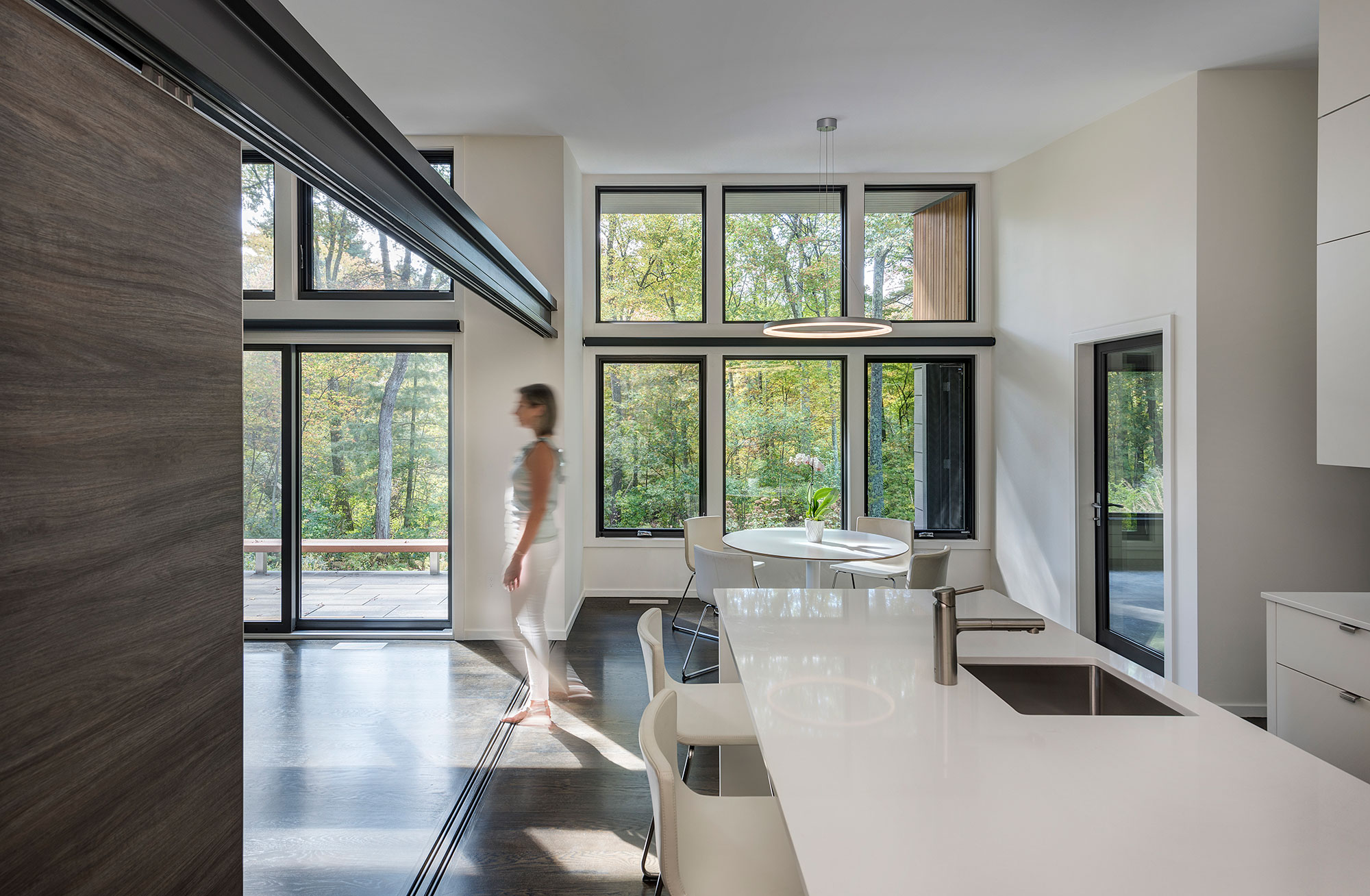 kitchen island and eat-in kitchen with exposed steel beam and sliding wall divider