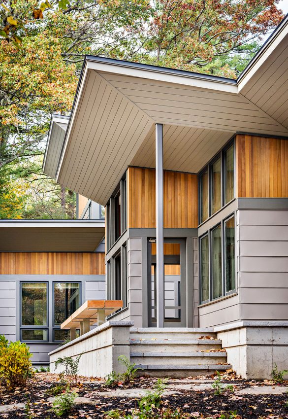 exterior of home with vertical cedar accents and warm grey metal siding