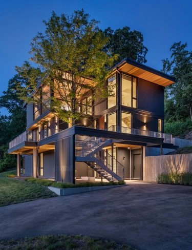 photo of exterior of annisquam river house at dusk
