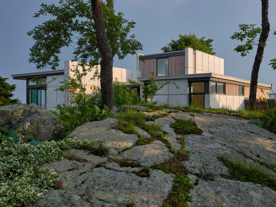 concrete home nestled into landscape with ledge