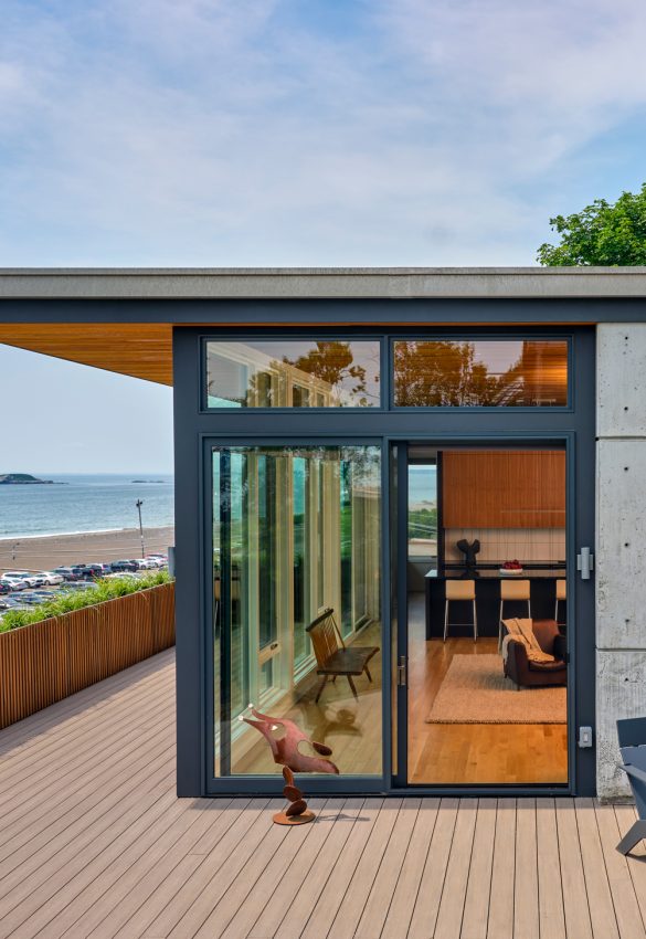 rear corner of home with deck overlooking ocean