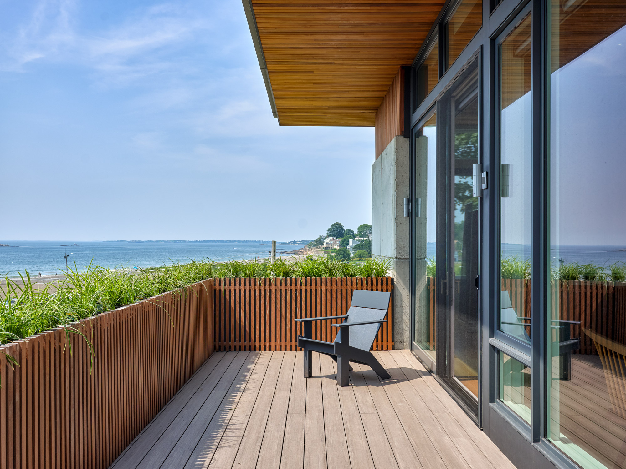 exterior deck with adirondack chair overlooking the ocean