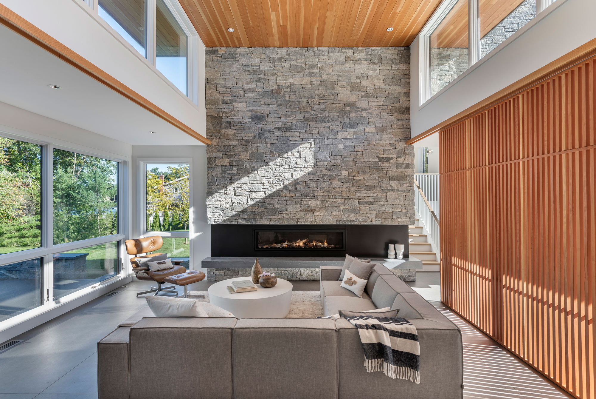 living room with massive stone fireplace