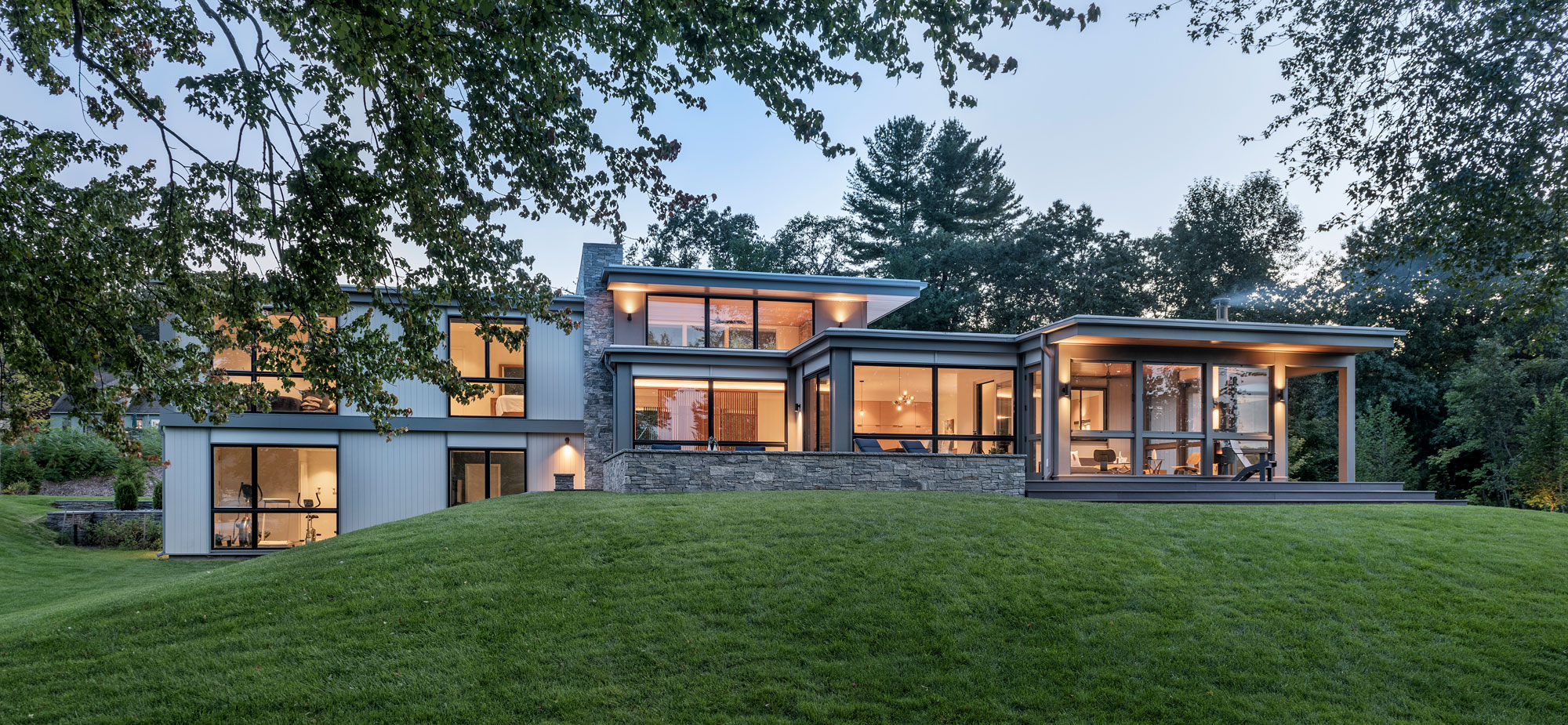 rear elevation nestled into landscape at dusk