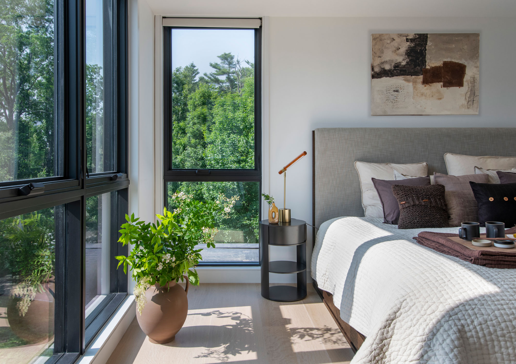 Bedroom with large windows in a elevated private canopy setting.